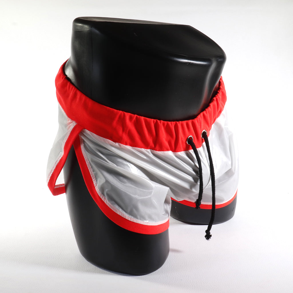 Mini - Short Vinyle – Blanc & Orange
Mini short vinyle blanc et orange effet brillant, créé par Omar Enrique Paris – mode masculine futuriste et style urbain.